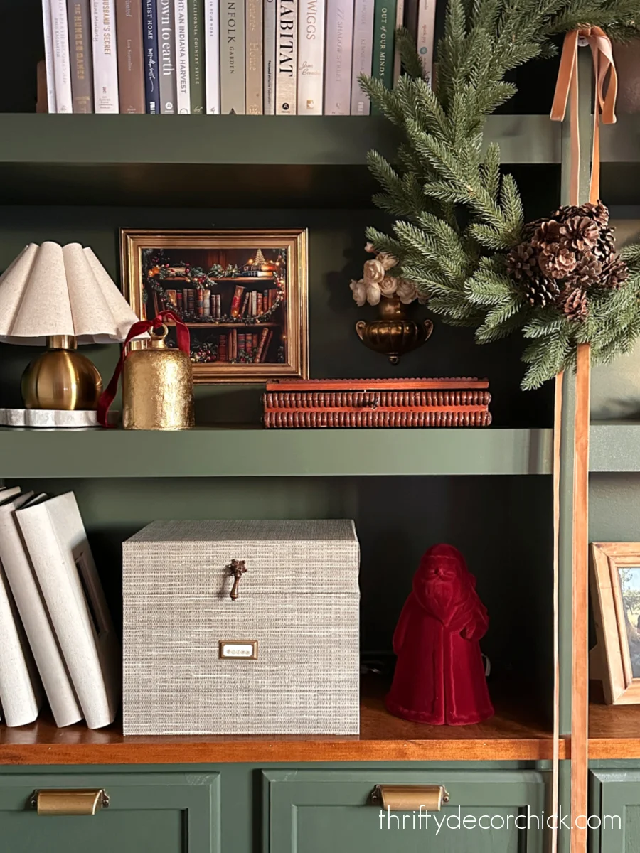 dark green bookcases with wreath